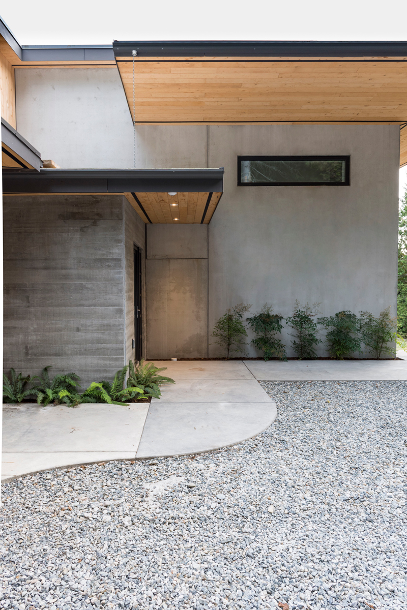 A structural concrete insulated panel (SCIP) home built by NZ Builders of Victoria, BC is set on a forested hillside on the Sunshine Coast of BC.